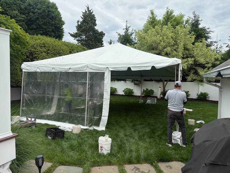 Frame tent with clear side walls, backyard install by our crew
