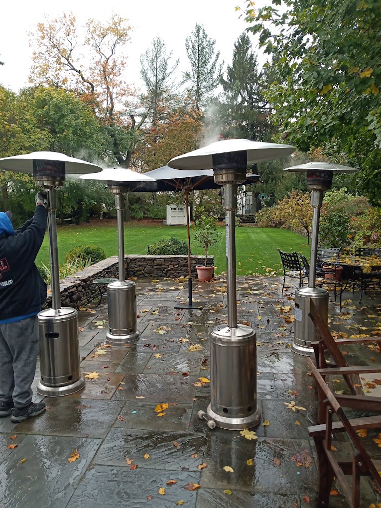 Stainless patio heaters on a stone patio
